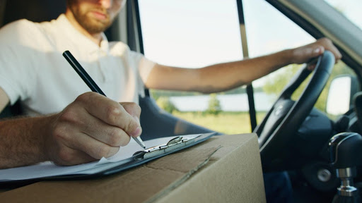 Man in van with clipboard